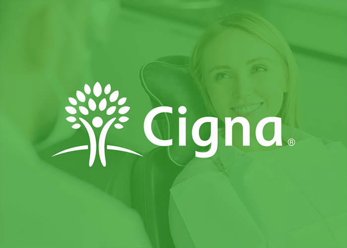 Cigna logo with smiling woman in green background for dental insurance branding