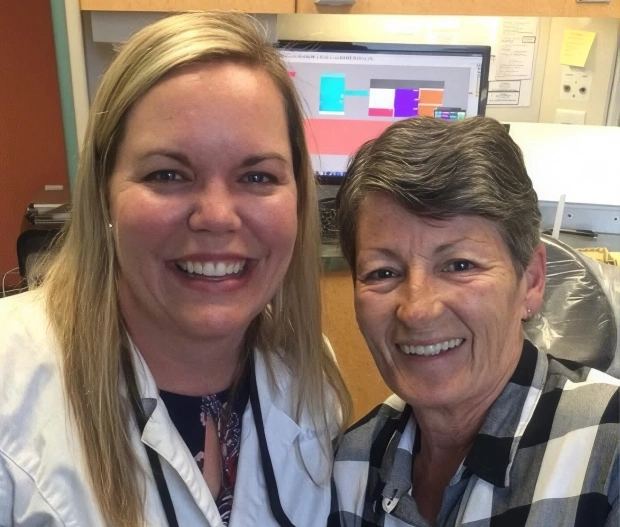 Dentist and patient smiling together