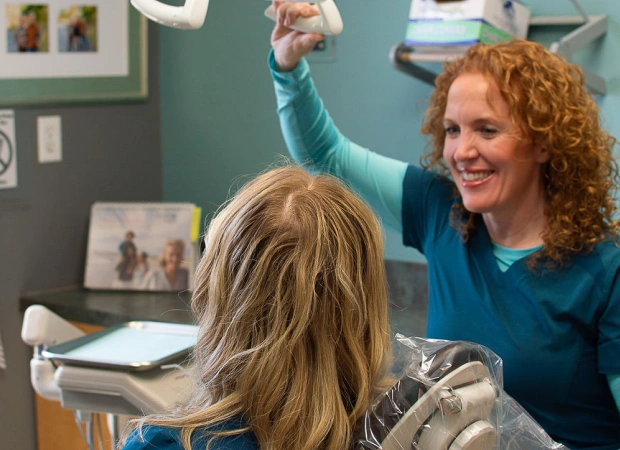 Dentist welcoming a young patient during a dental visit