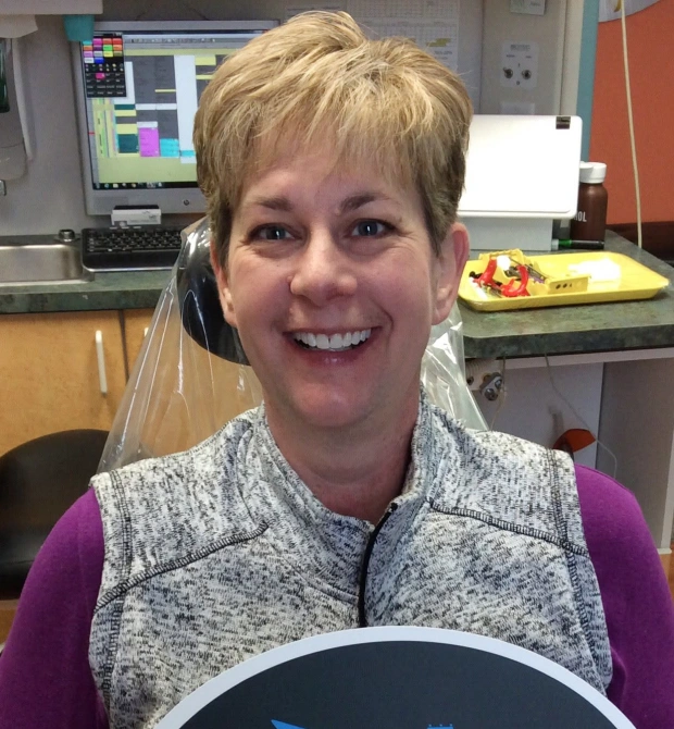 Patient smiling after professional teeth whitening treatment